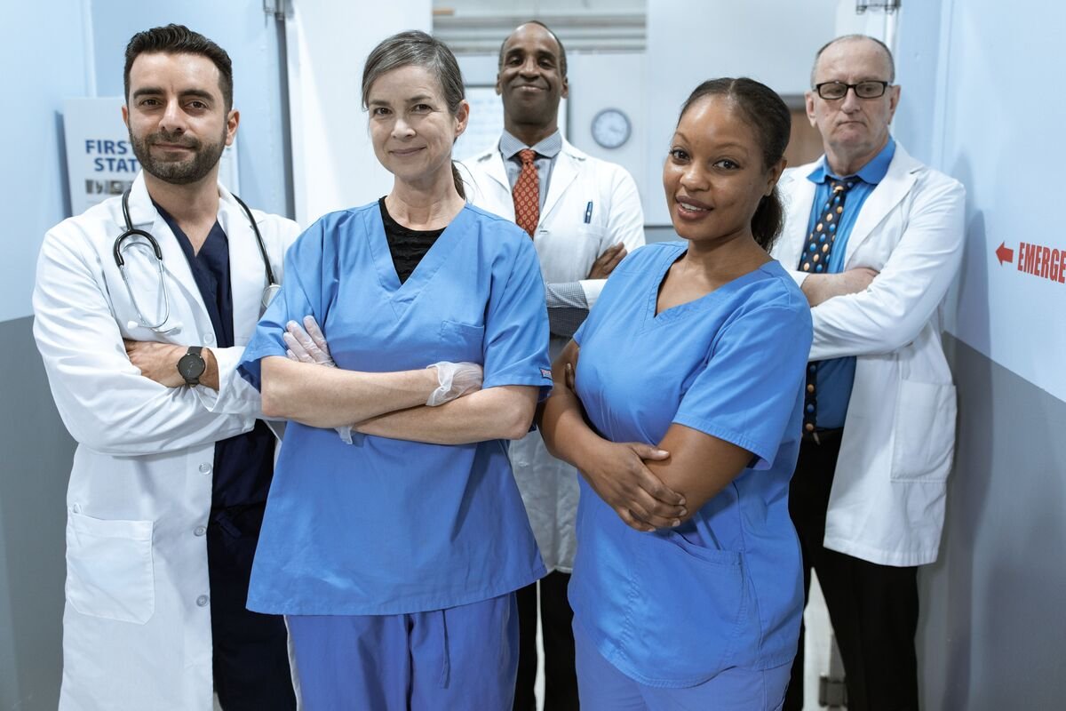 Diverse team of doctors and nurses standing confidently in a hospital hallway