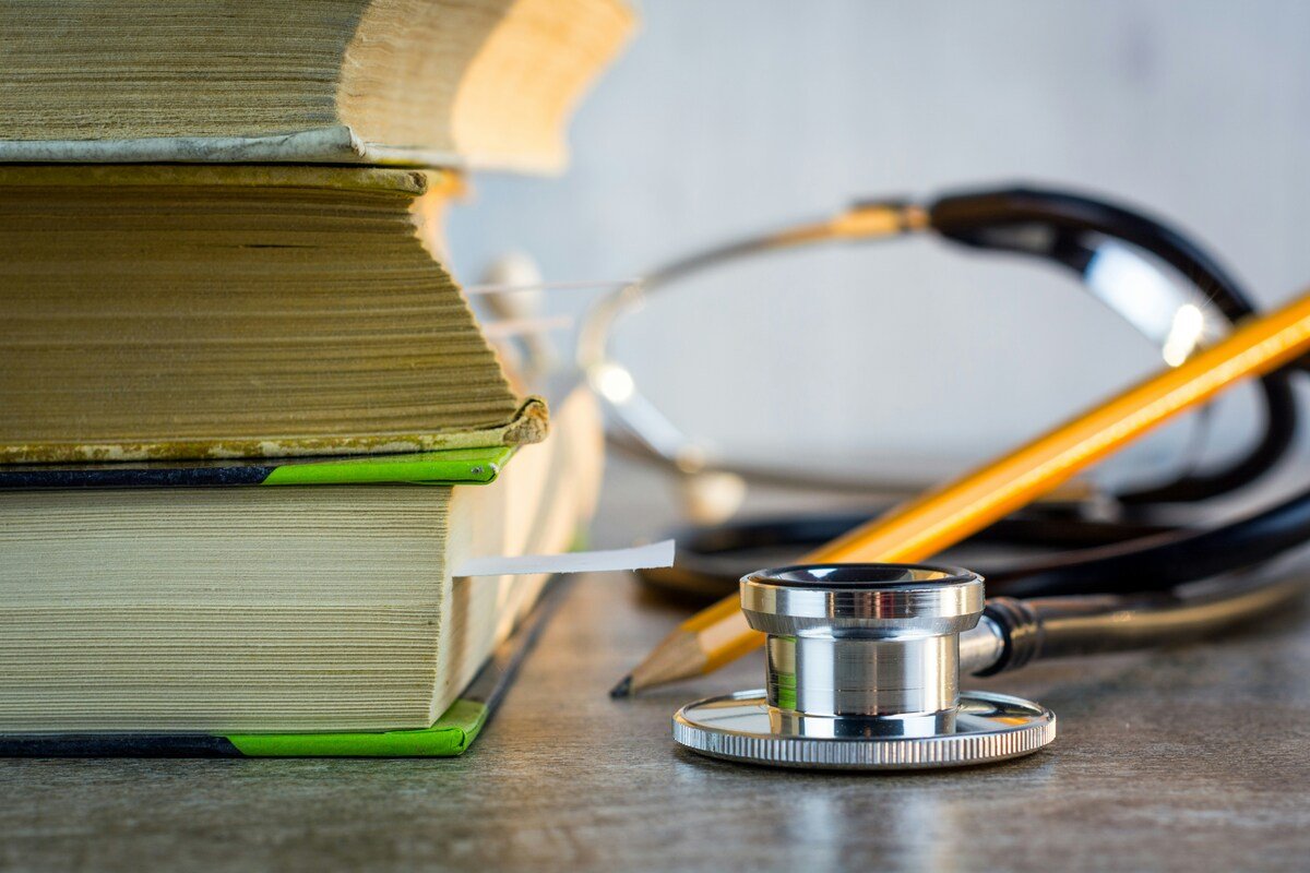 Medical reference books and stethoscope representing StressHealed's trusted health sources