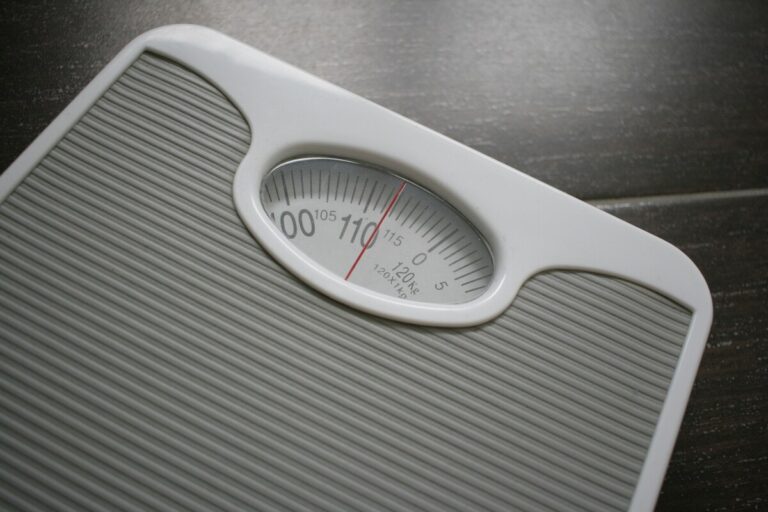 Workplace Stress and Weight Gain concept shown with a weighing scale measuring high body weight.